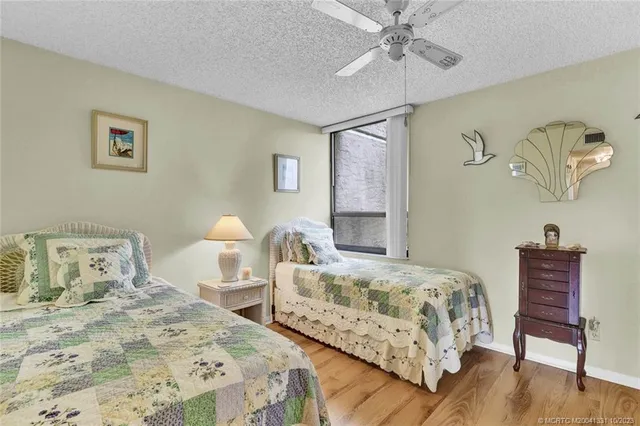 a bedroom with two beds and painting on the wall