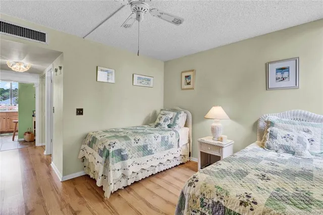 a bedroom with bed and a chandelier