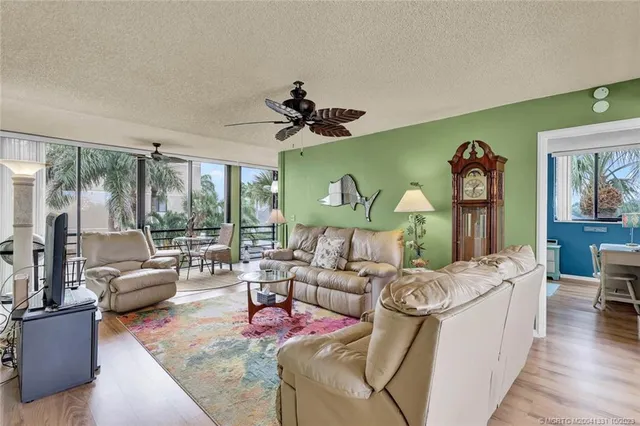 a living room with furniture a fireplace and a chandelier
