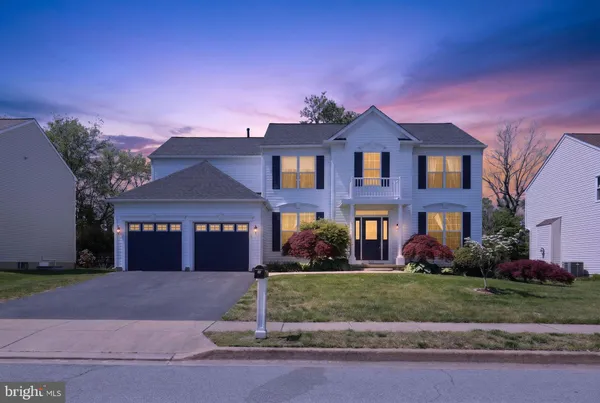 a front view of a house with a garden and garage