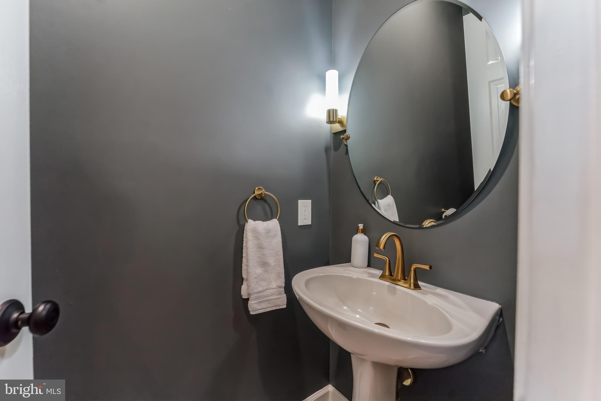 2116 Elm Tree Lane Silver Spring, MD 20906 - Photo 15 of 32 a bathroom with a sink and mirror