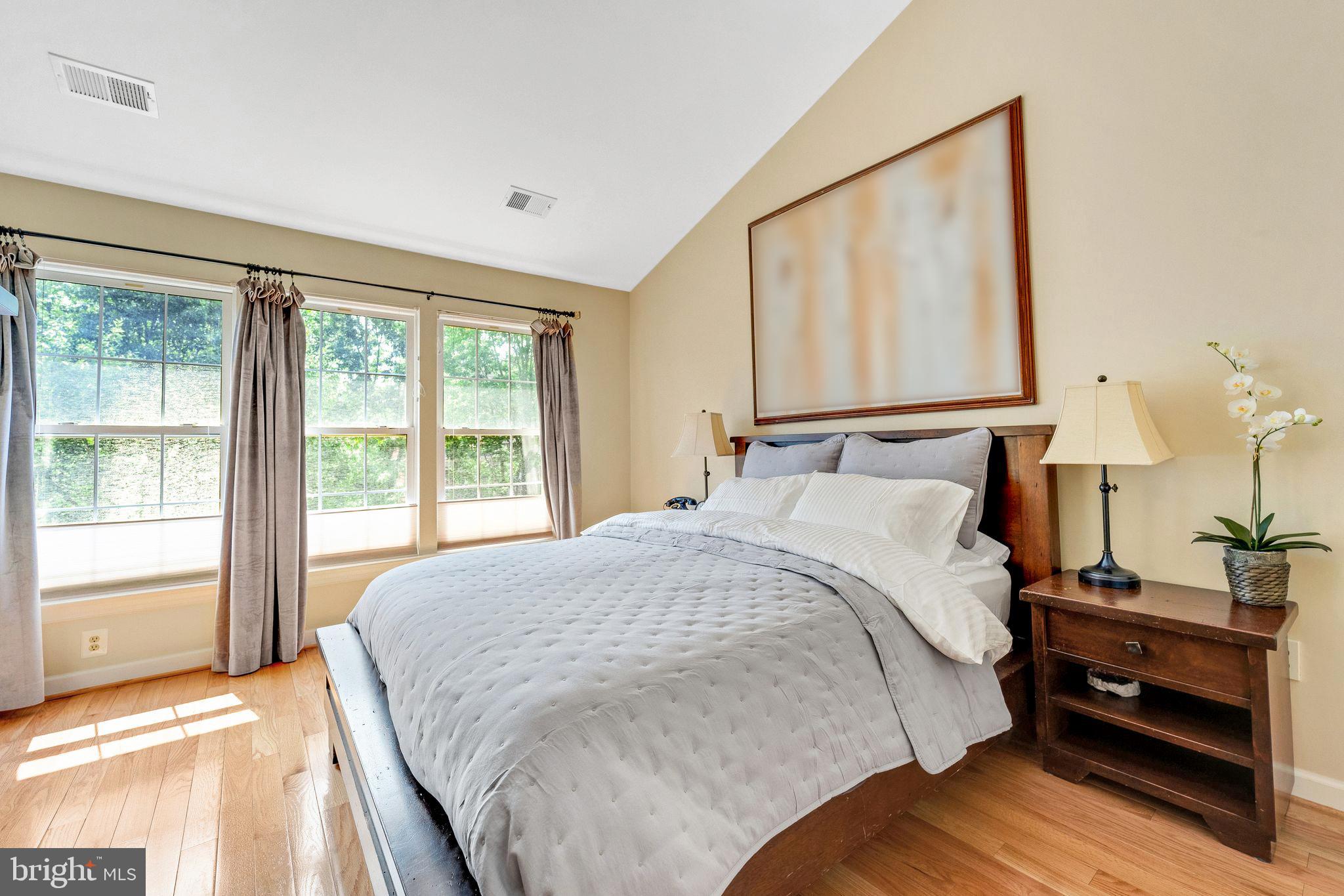 2116 Elm Tree Lane Silver Spring, MD 20906 - Photo 17 of 32 a bedroom with a bed and two large window