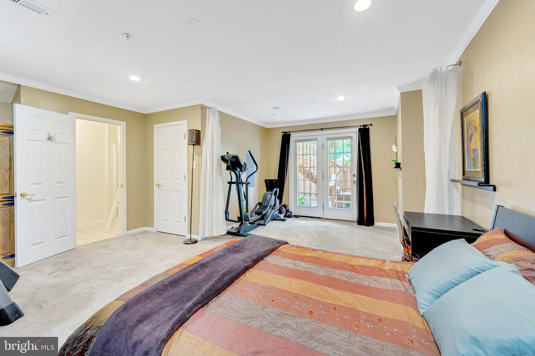 2116 Elm Tree Lane Silver Spring, MD 20906 - Photo 25 of 32 a bedroom with a bed and a large mirror