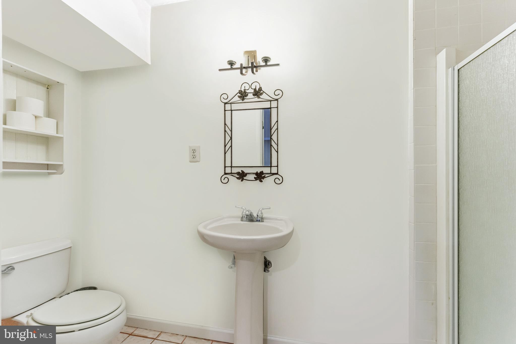 2116 Elm Tree Lane Silver Spring, MD 20906 - Photo 26 of 32 a bathroom with a sink toilet and a mirror