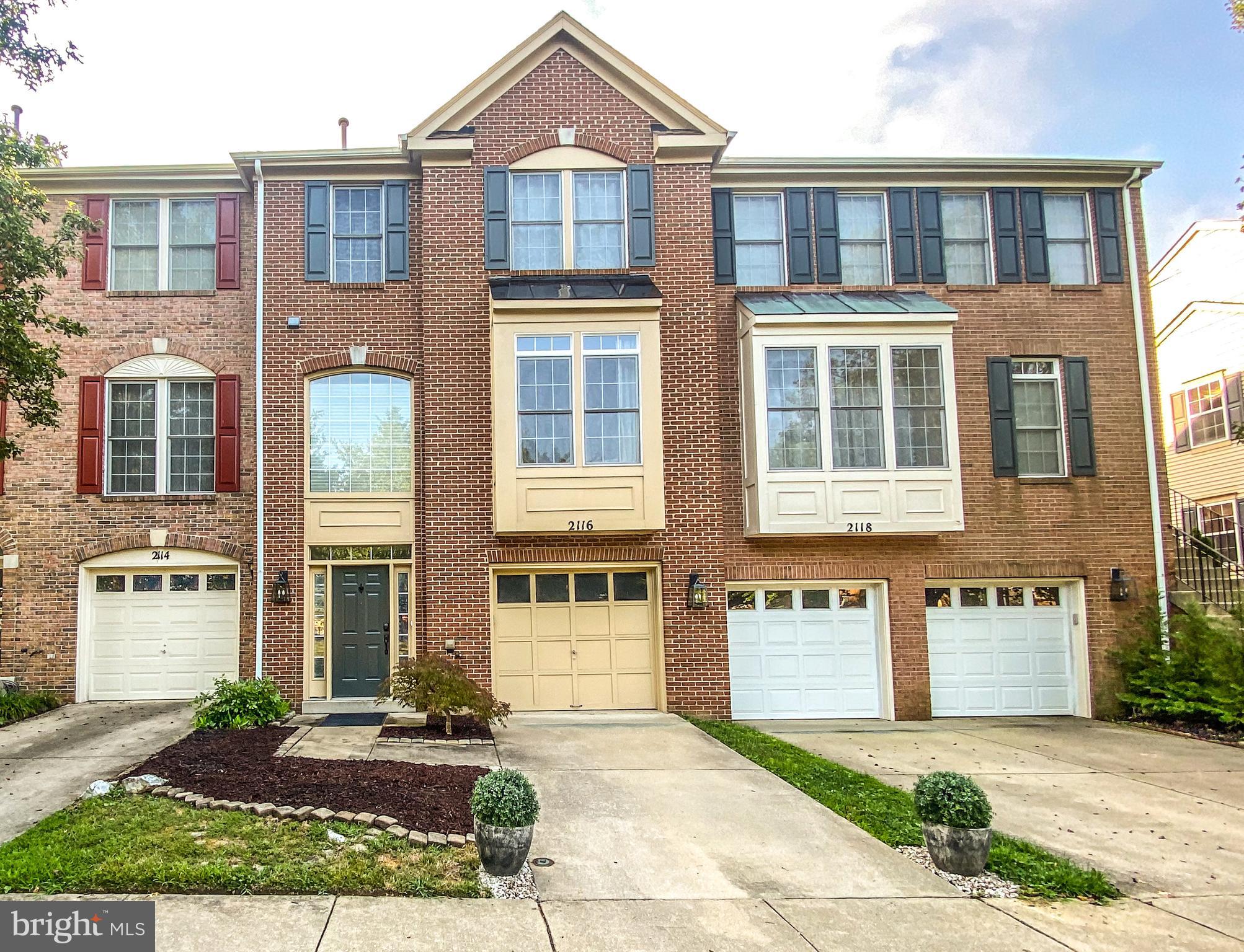2116 Elm Tree Lane Silver Spring, MD 20906 - Photo 31 of 32 a front view of a residential apartment building with a yard and outdoor seating