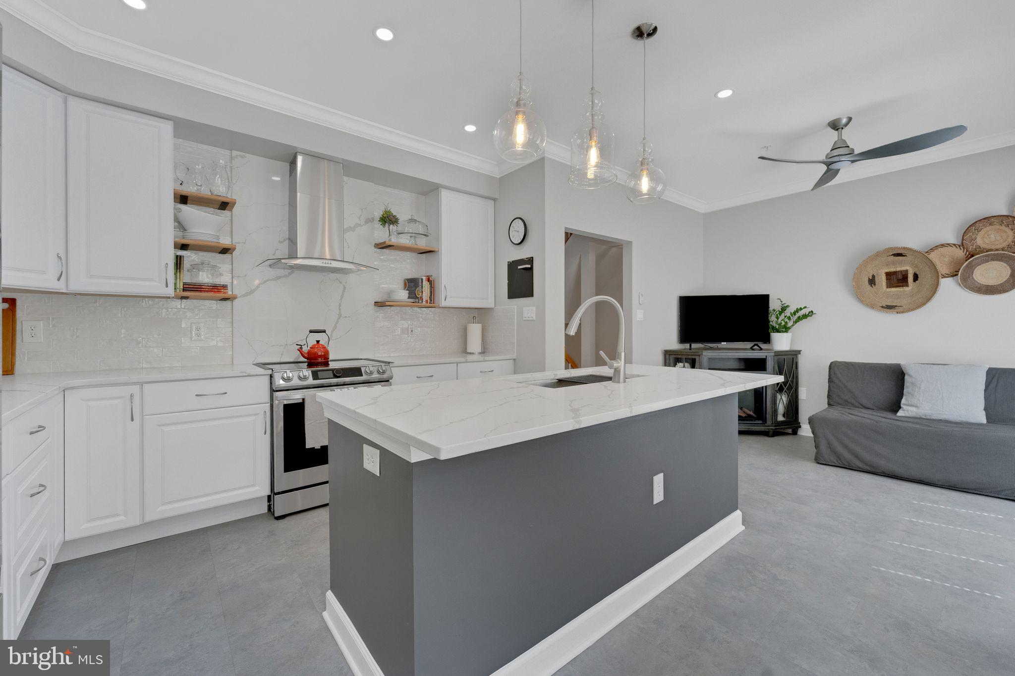 2116 Elm Tree Lane Silver Spring, MD 20906 - Photo 5 of 32 a kitchen with a sink stove and cabinets
