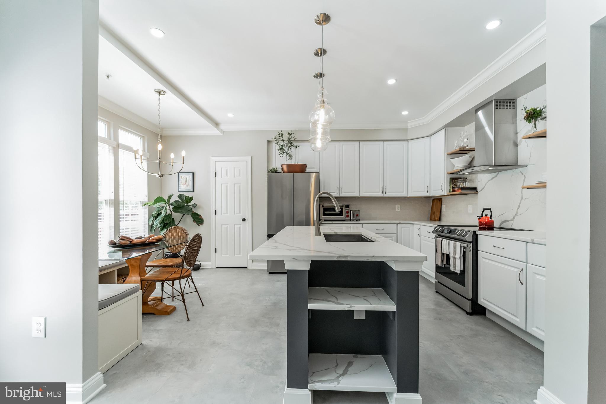 2116 Elm Tree Lane Silver Spring, MD 20906 - Photo 6 of 32 a living room with stainless steel appliances kitchen island a table and chairs in it