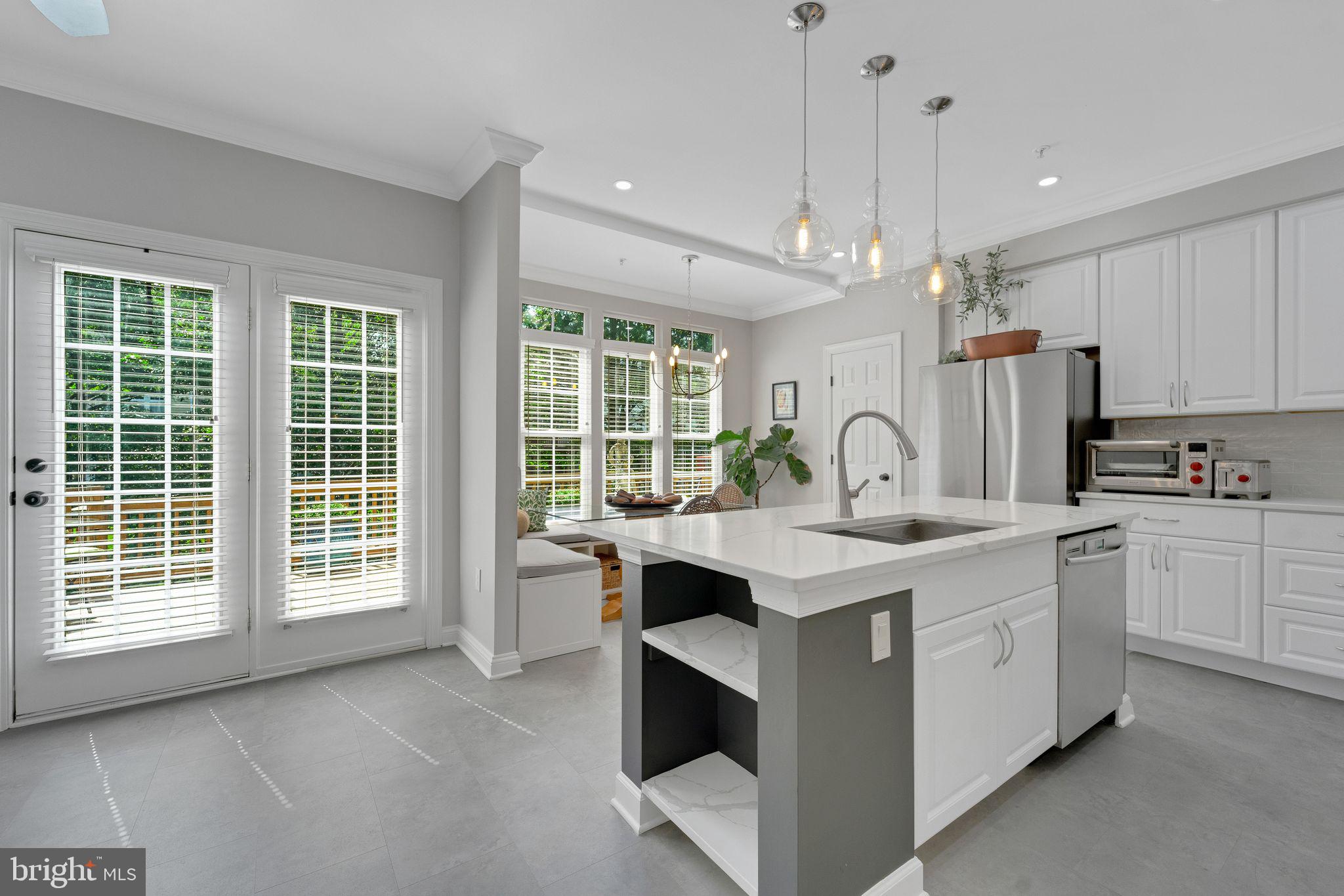 2116 Elm Tree Lane Silver Spring, MD 20906 - Photo 8 of 32 a view of cabinets a kitchen island a sink a stove and a window