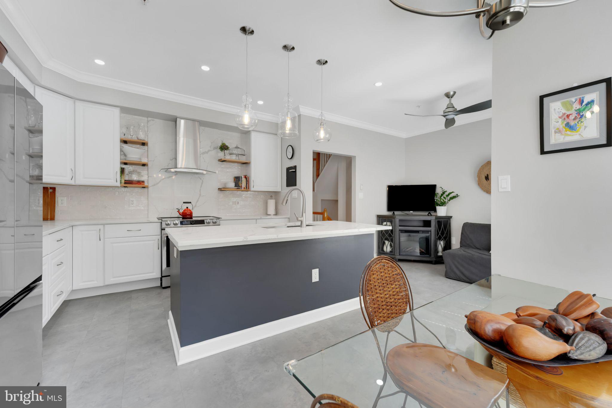 2116 Elm Tree Lane Silver Spring, MD 20906 - Photo 9 of 32 a kitchen with stainless steel appliances kitchen island granite countertop a sink and cabinets