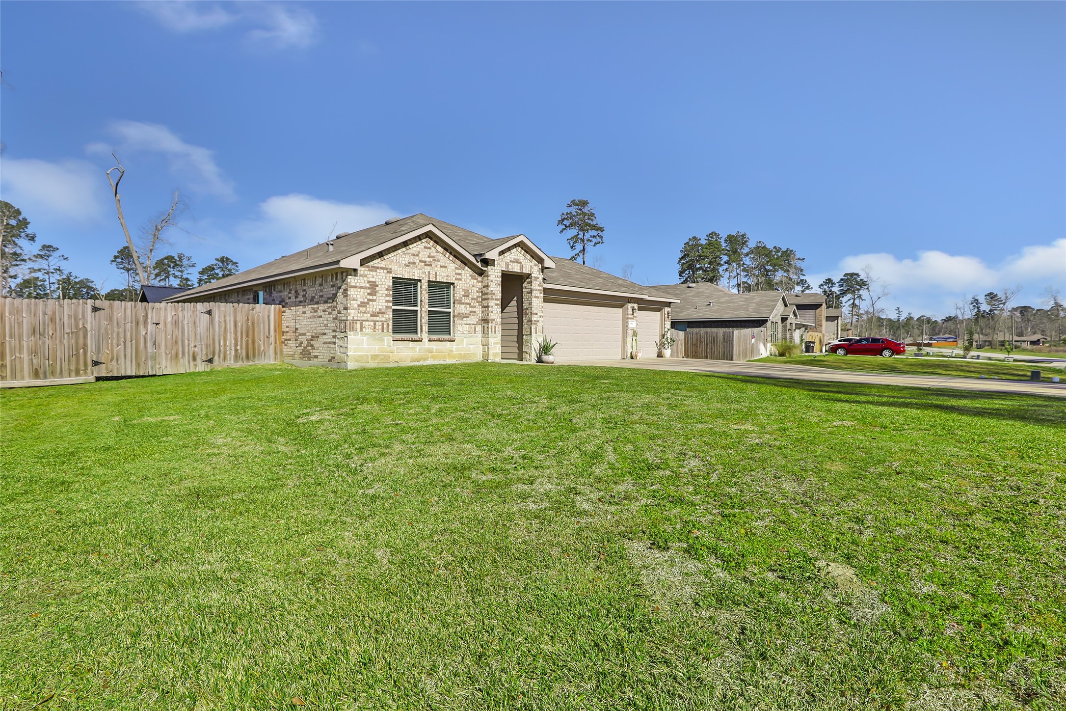 811 Republic Road New Caney, TX 77357 - Photo 2 of 37 Charming single-story brick home with a spacious front lawn and a wooden fence. Located in a quiet, tree-lined neighborhood, it offers a welcoming and serene environment. Ideal for families seeking a cozy, suburban lifestyle.