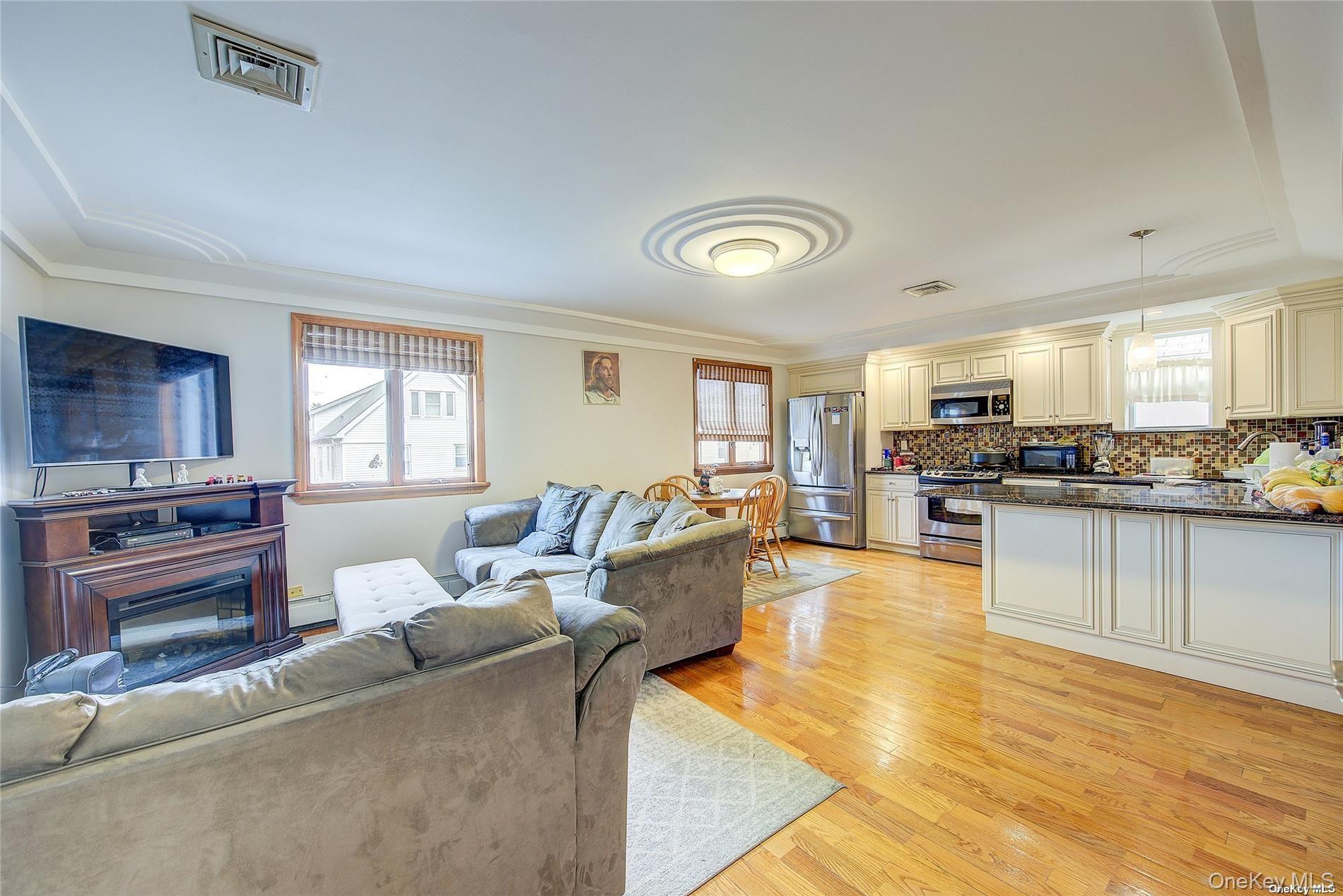 43-33 163rd Street Queens, NY 11358 - Photo 11 of 31 a living room with furniture and kitchen view