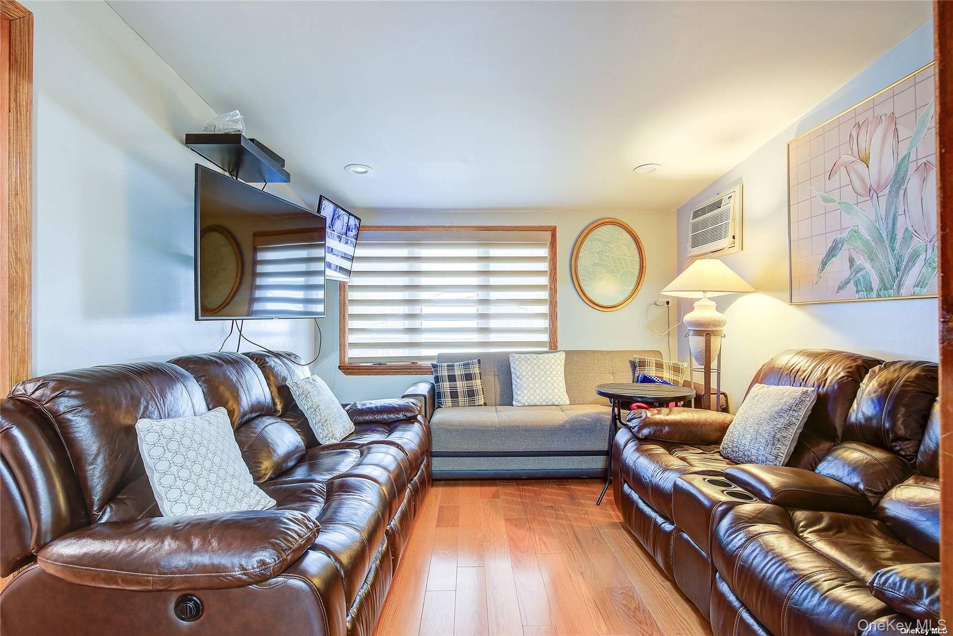 43-33 163rd Street Queens, NY 11358 - Photo 19 of 31 a living room with furniture and a large window