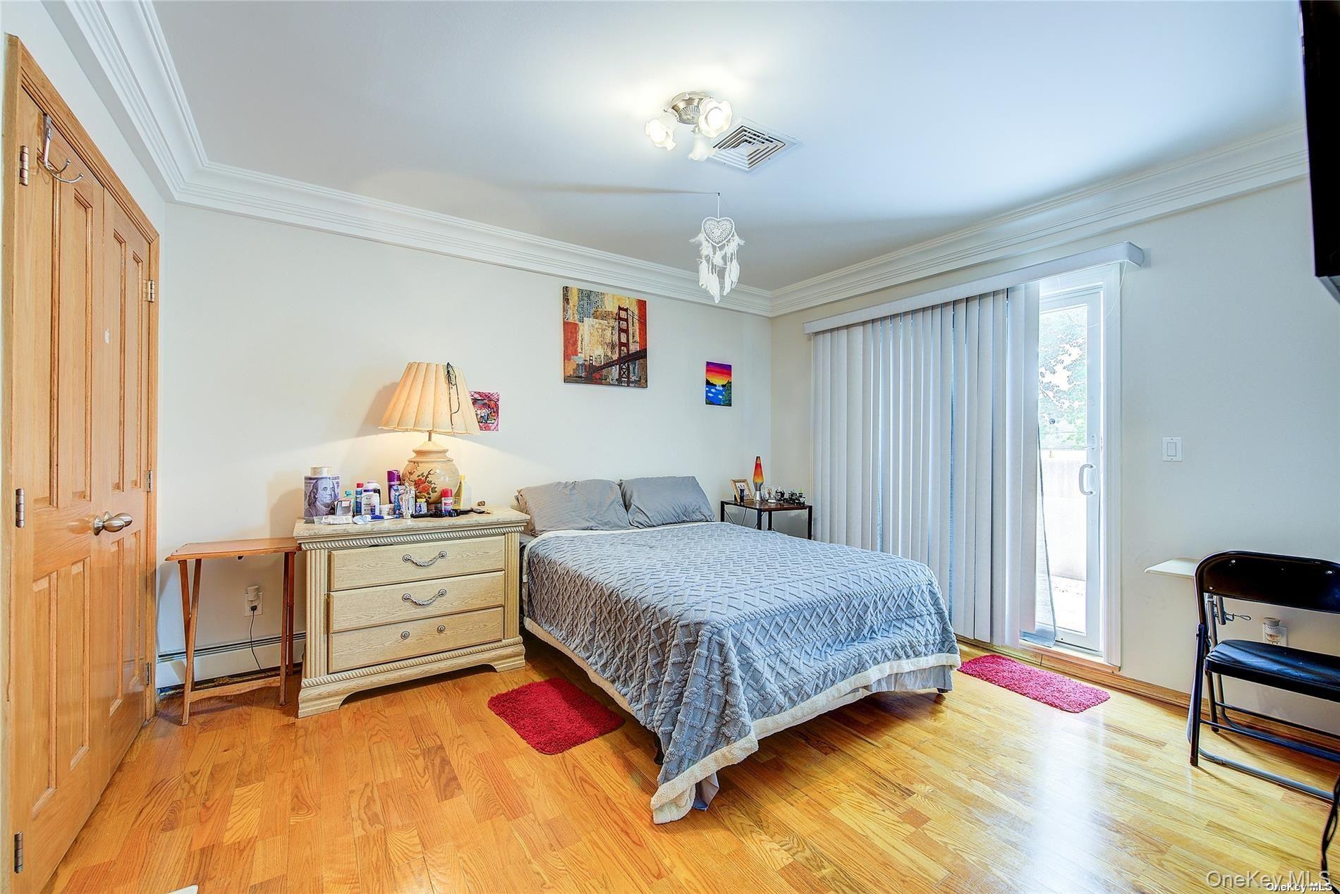 43-33 163rd Street Queens, NY 11358 - Photo 20 of 31 a bedroom with a bed and a dresser in it