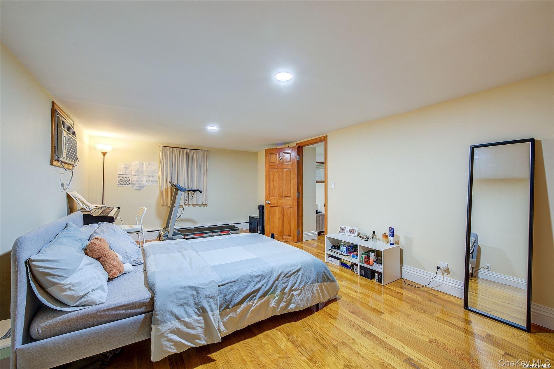 43-33 163rd Street Queens, NY 11358 - Photo 21 of 31 a bedroom with a bed and a couch