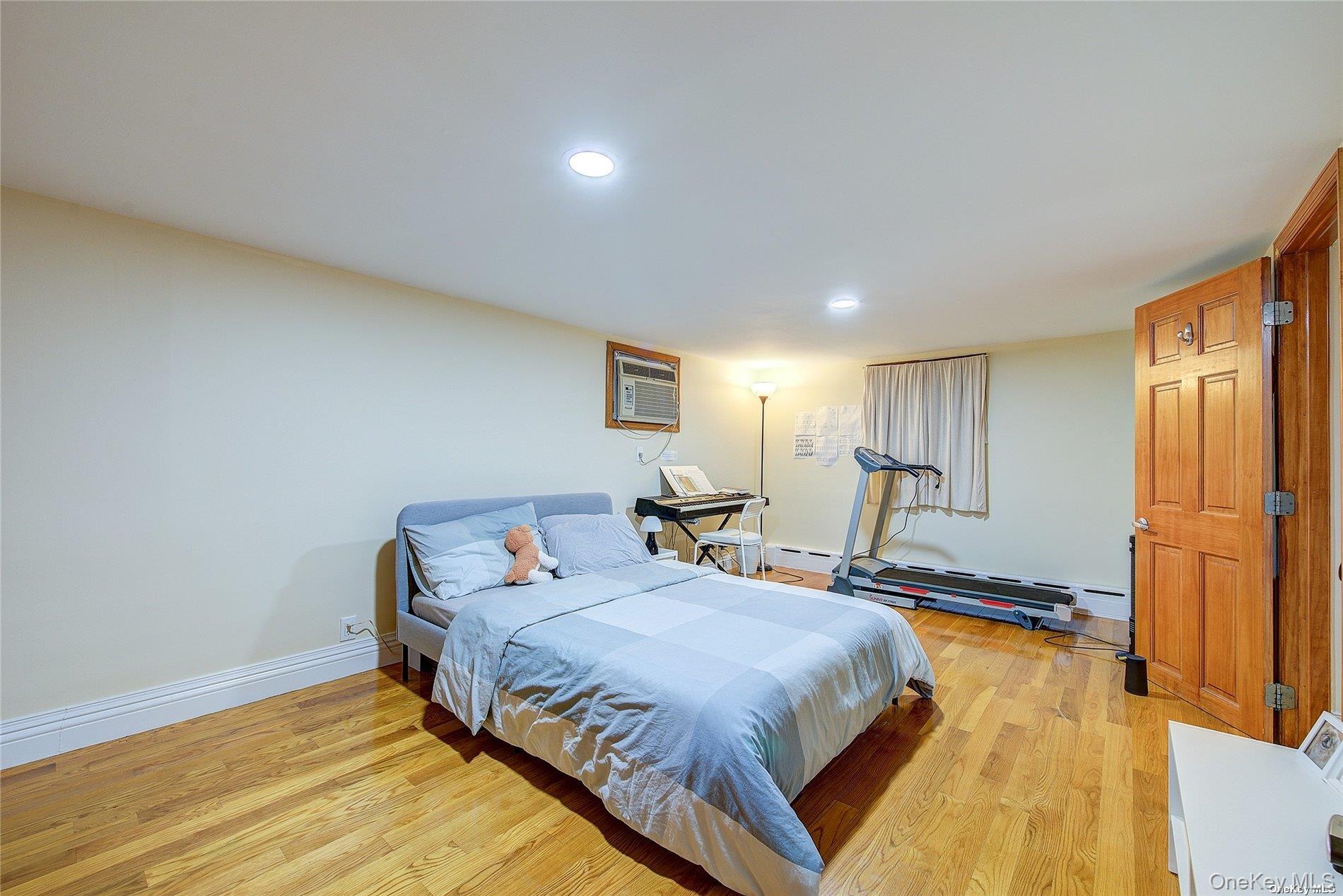 43-33 163rd Street Queens, NY 11358 - Photo 22 of 31 a bedroom with a bed and wooden floor
