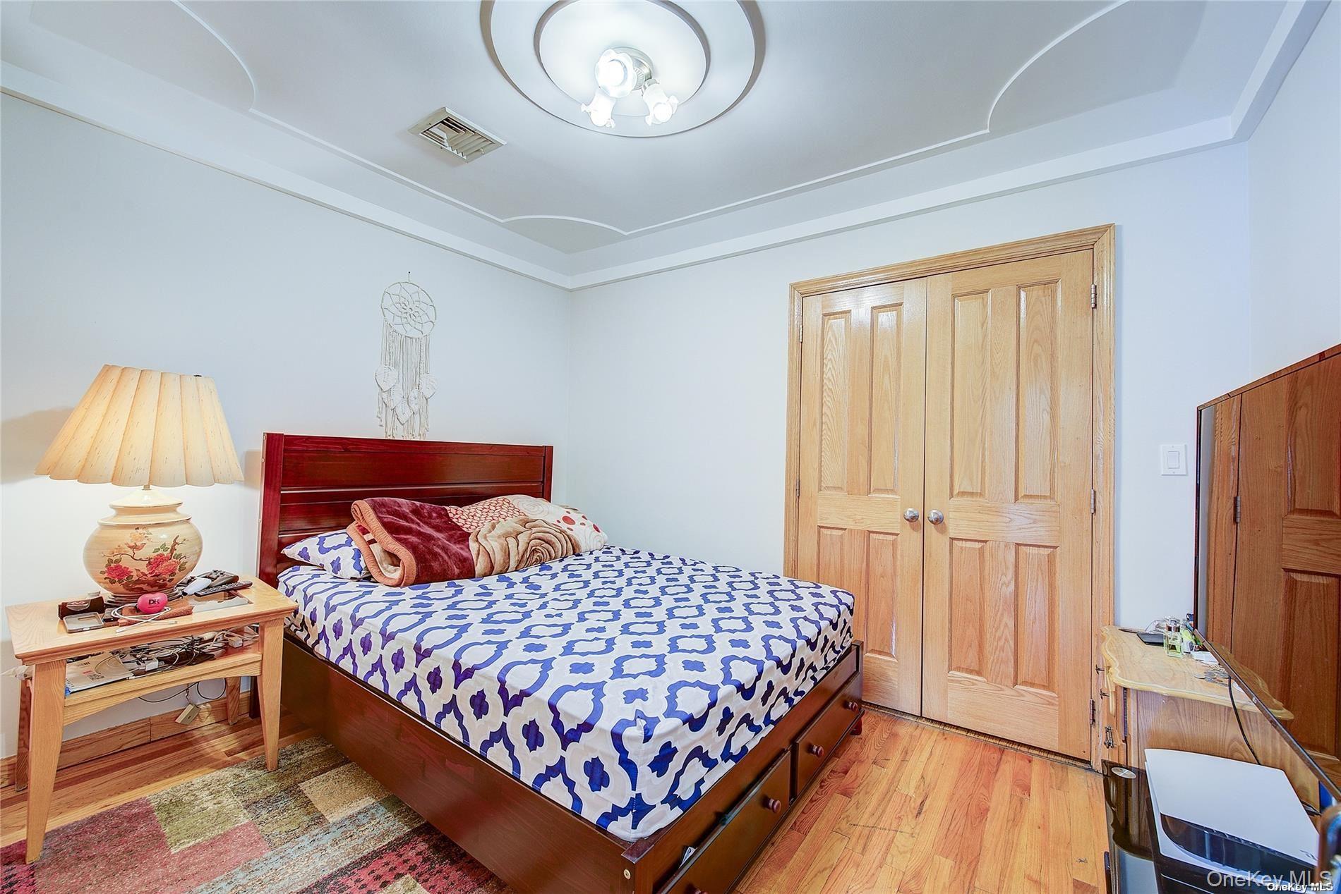 43-33 163rd Street Queens, NY 11358 - Photo 23 of 31 a bedroom with a bed and a dresser