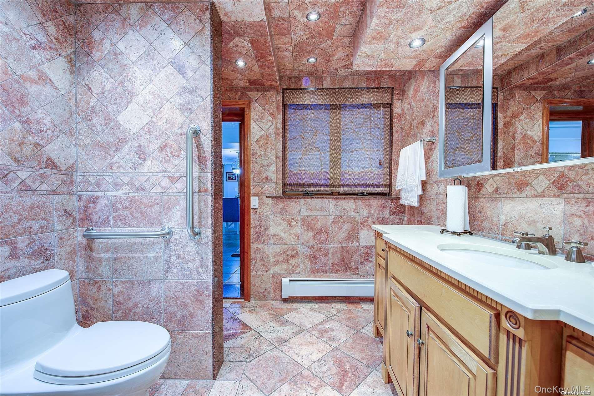 43-33 163rd Street Queens, NY 11358 - Photo 26 of 31 a bathroom with a sink a toilet and shower