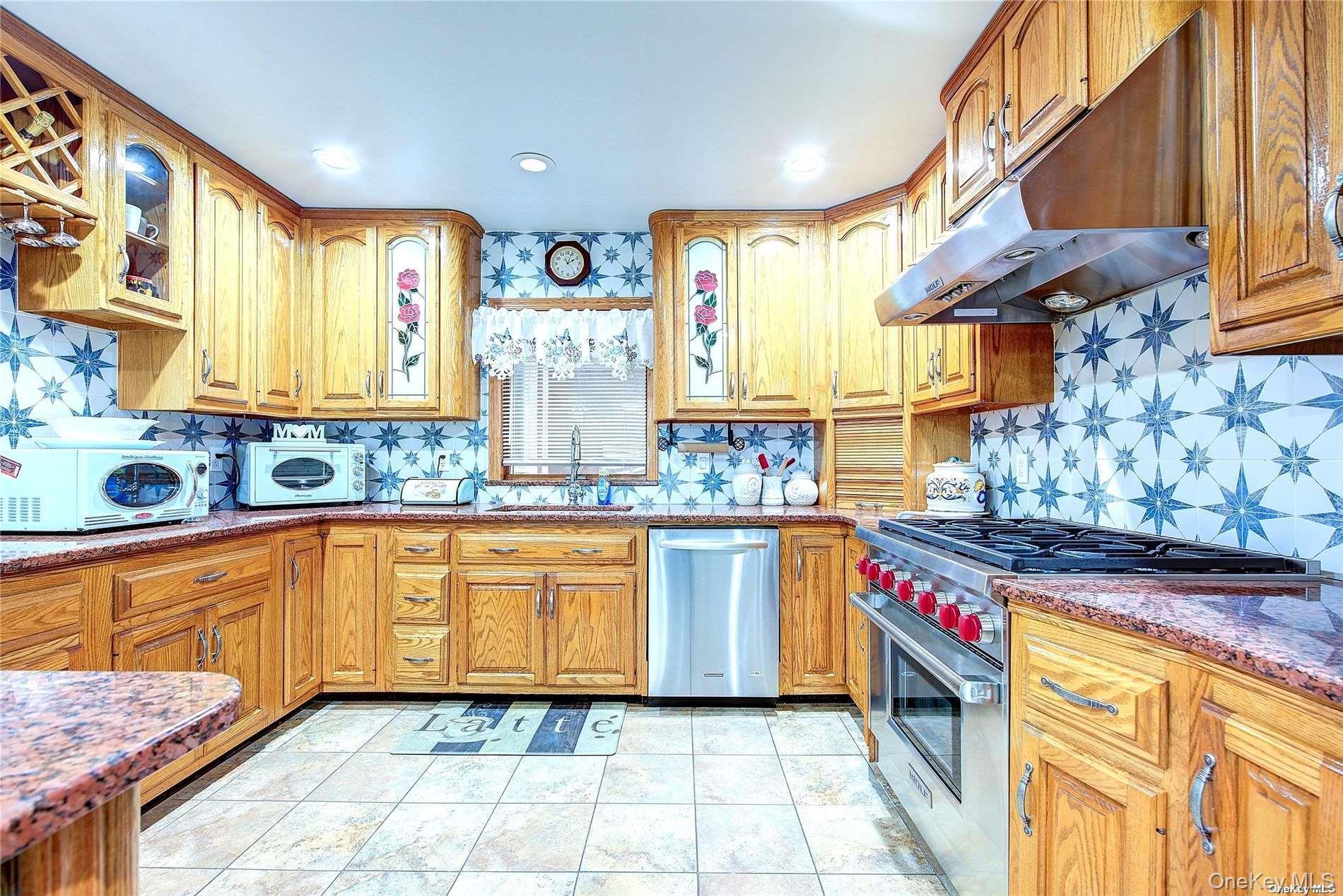43-33 163rd Street Queens, NY 11358 - Photo 6 of 31 a kitchen with stainless steel appliances granite countertop a stove a sink and a microwave