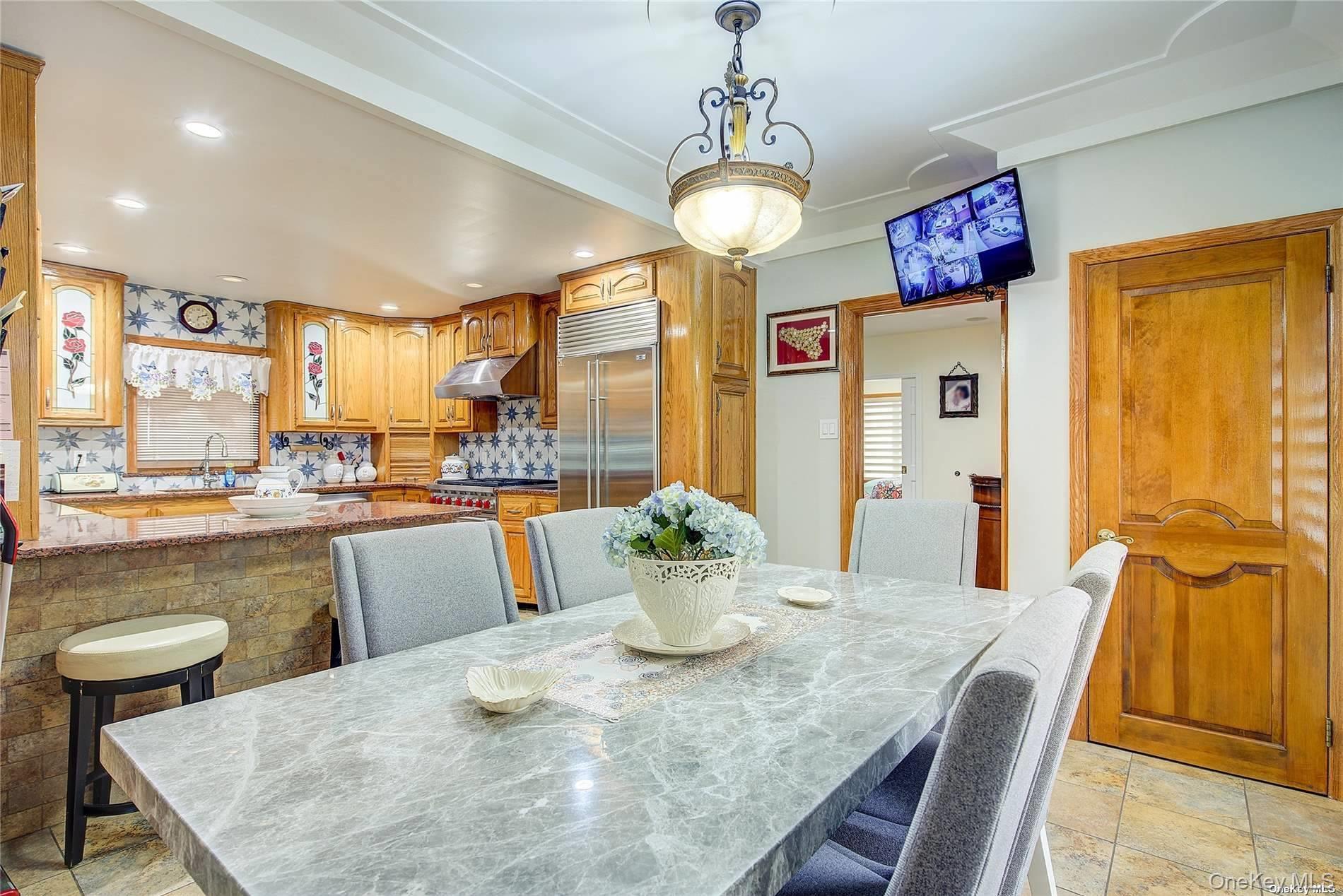 43-33 163rd Street Queens, NY 11358 - Photo 10 of 31 a kitchen with a table and chairs in it
