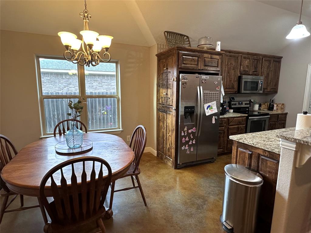 1212 Bowman Ridge Road Stephenville, TX 76401 - Photo 10 of 23 a view of a dining room with furniture a chandelier and large window