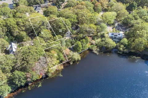 an aerial view of a house with a yard and garden