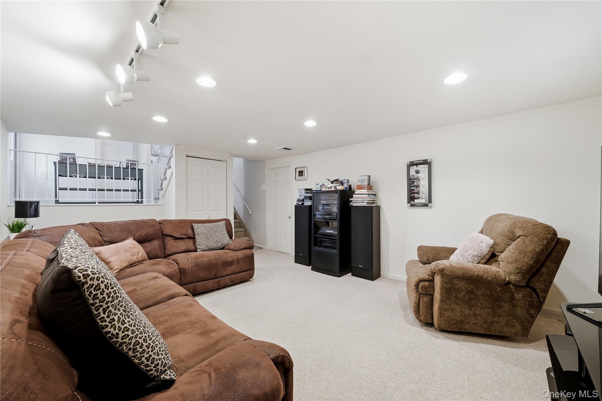 1853 Decatur Avenue Merrick, NY 11566 - Photo 32 of 43 a living room with furniture and a couch