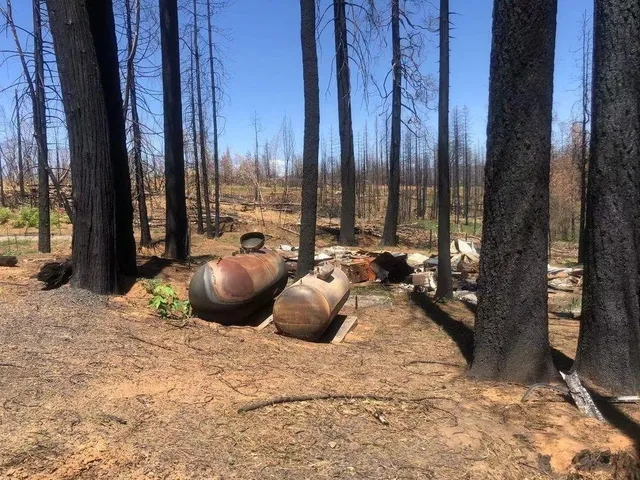 a view of two chairs and tables in the patio