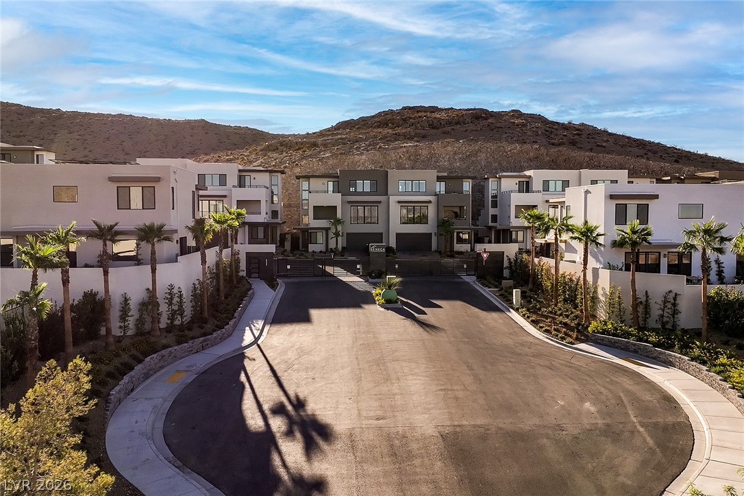 11027 Socrates Ridge Street Las Vegas, NV 89141 - Photo 20 of 20 A cul-de-sac of modern townhomes offers a secluded neighborhood experience with mountain views.