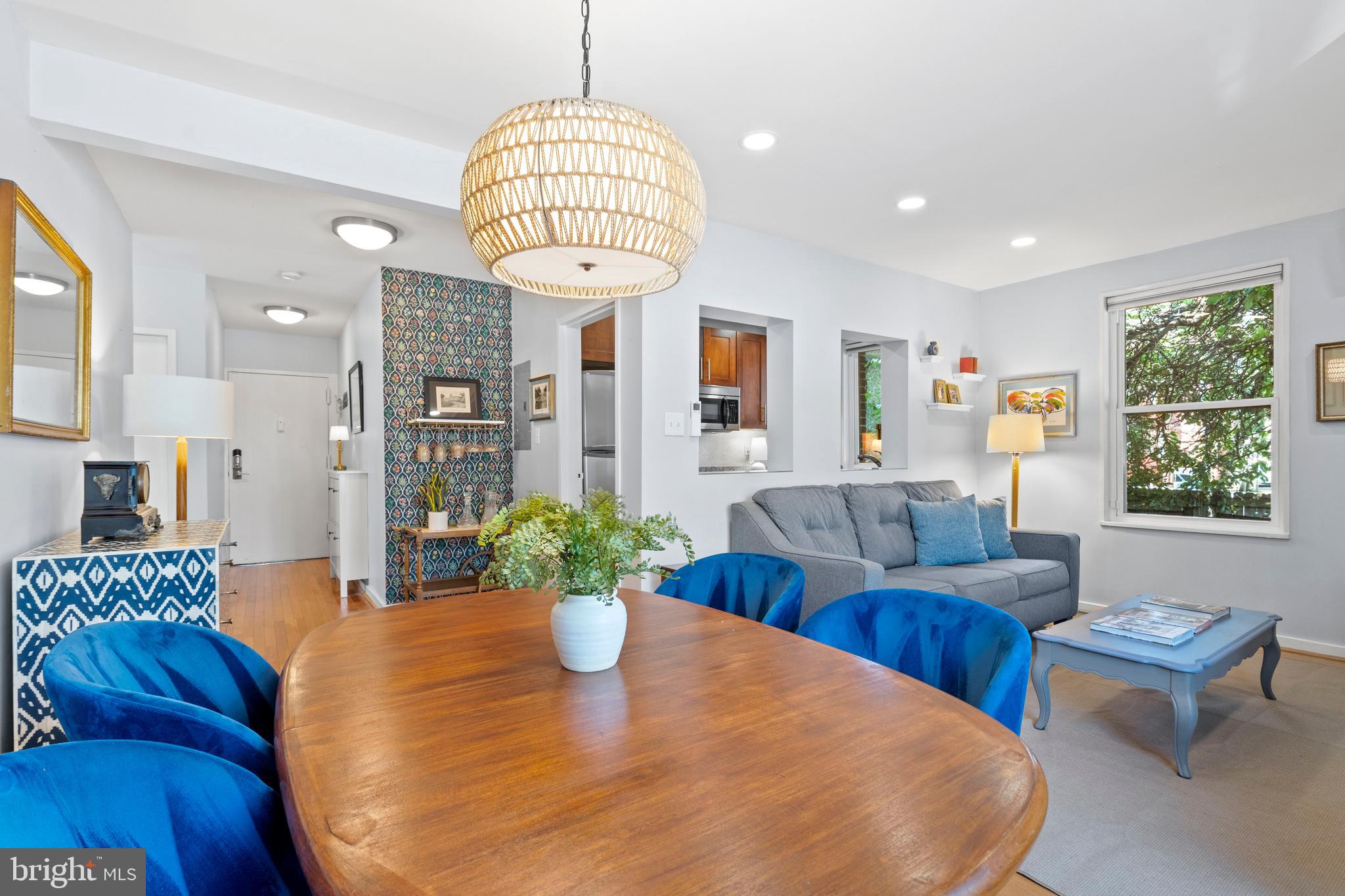 a living room with dining table furniture and a chandelier