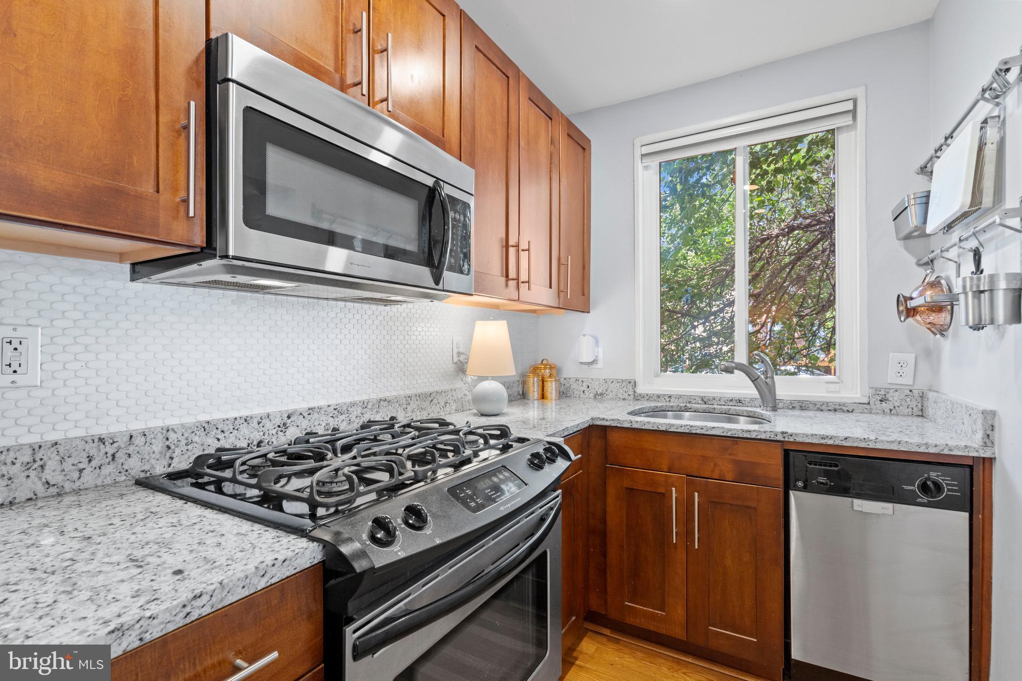 2639 15th Street Northwest, Unit 104 Washington, DC 20009 - Photo 15 of 36 a kitchen with a stove and a microwave