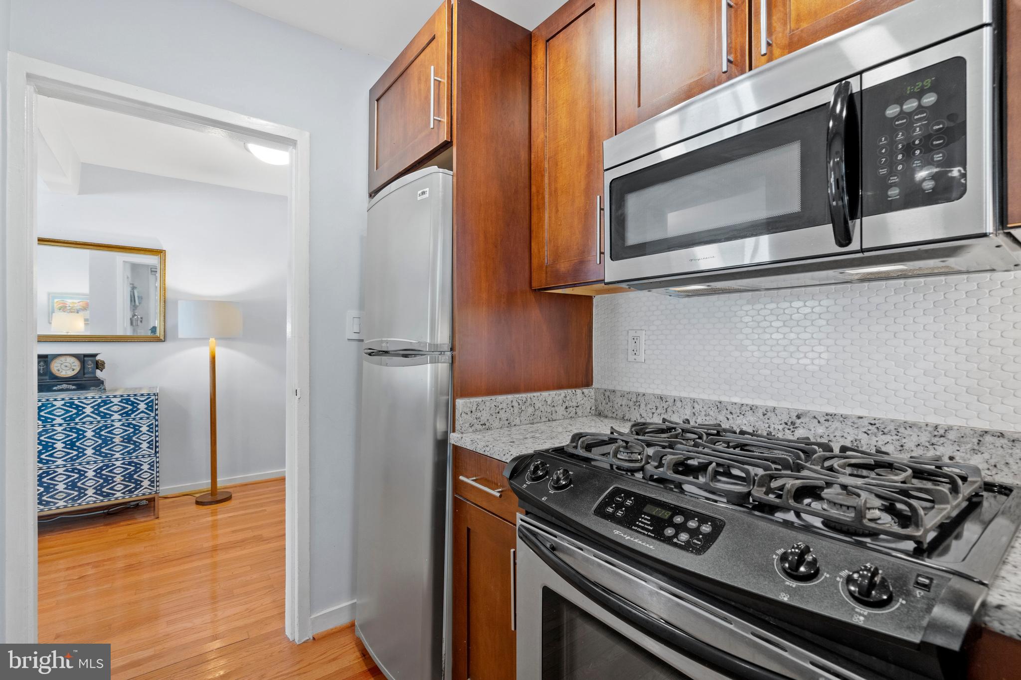 2639 15th Street Northwest, Unit 104 Washington, DC 20009 - Photo 17 of 36 a stove top oven sitting inside of a kitchen