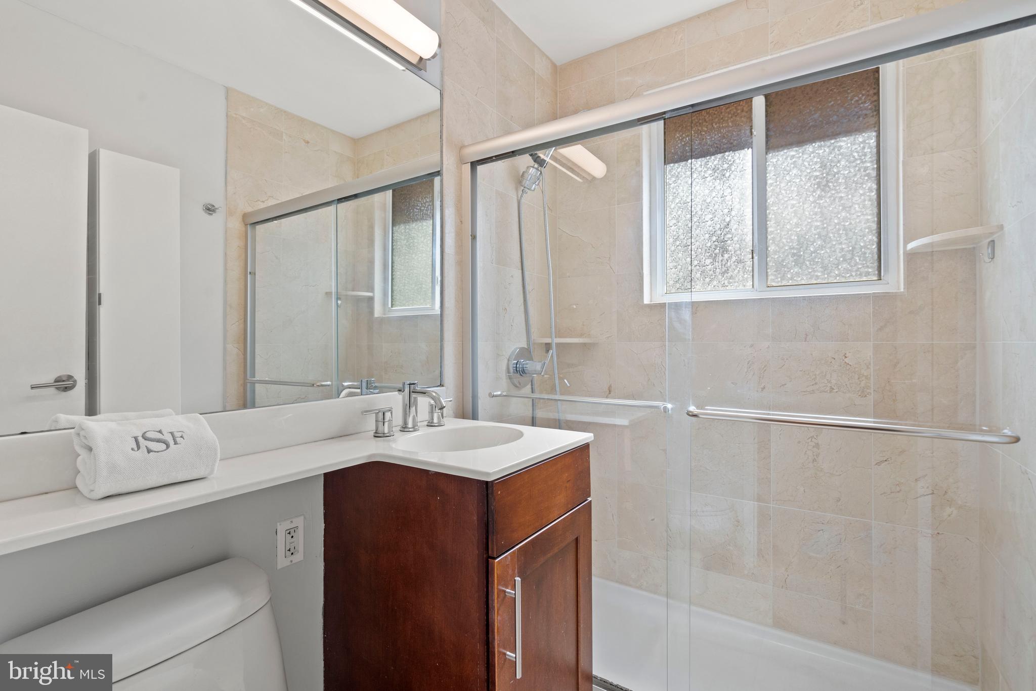 2639 15th Street Northwest, Unit 104 Washington, DC 20009 - Photo 19 of 36 a bathroom with a double vanity sink and a mirror