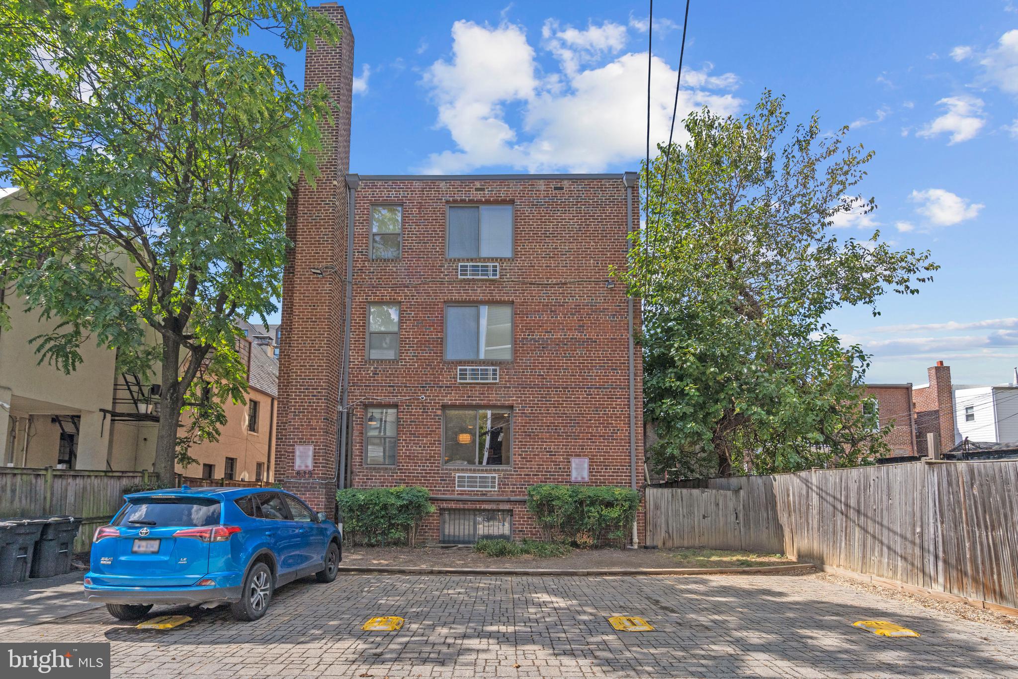 2639 15th Street Northwest, Unit 104 Washington, DC 20009 - Photo 29 of 36 a red car parked in front of a brick house