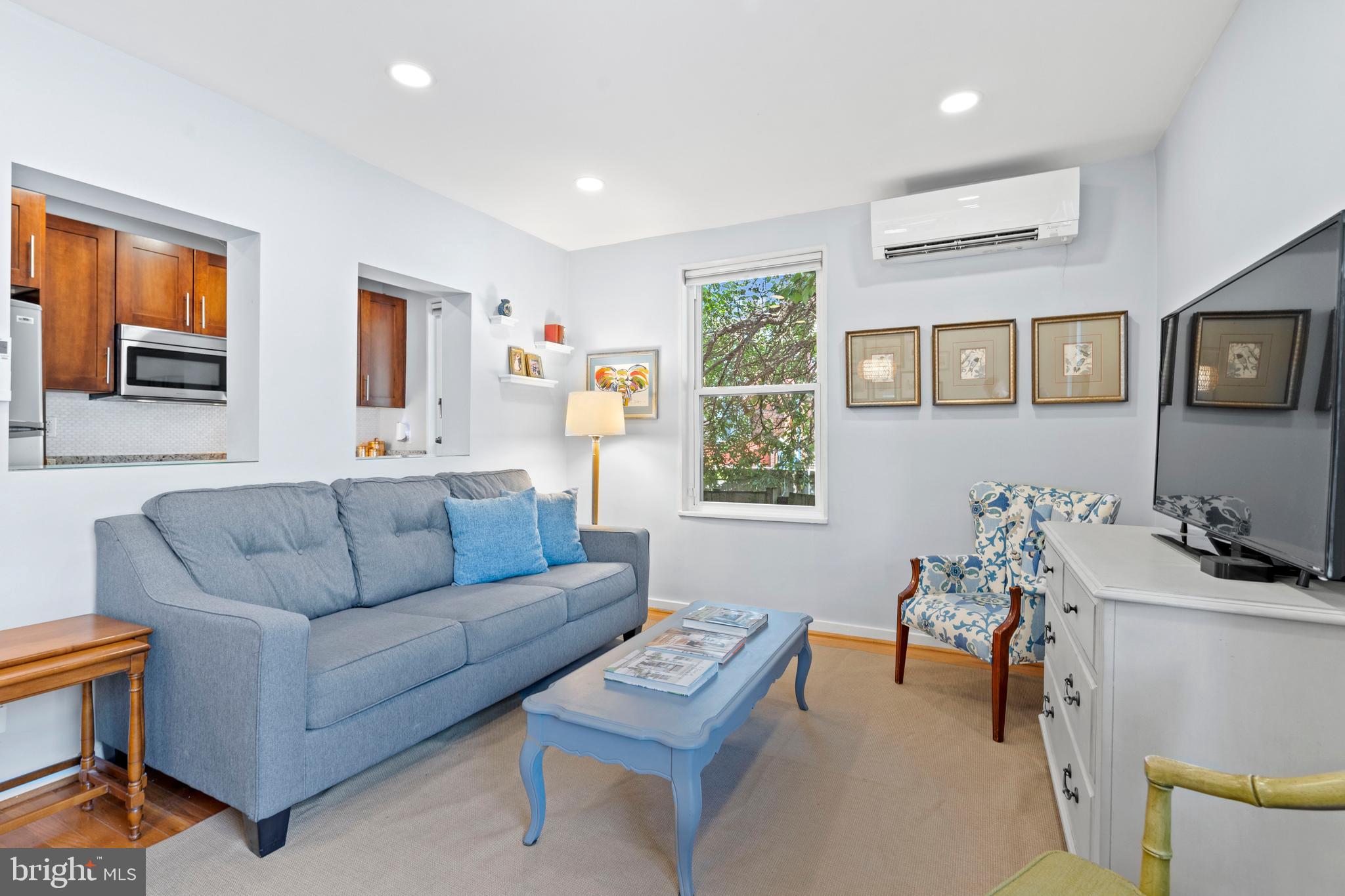 2639 15th Street Northwest, Unit 104 Washington, DC 20009 - Photo 9 of 36 a living room with furniture and a window