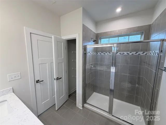 a bathroom with a shower and a sink