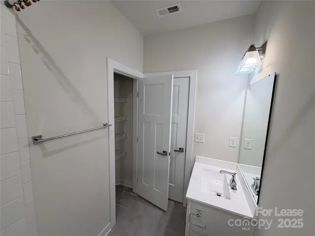 a bathroom with a tub sink and vanity