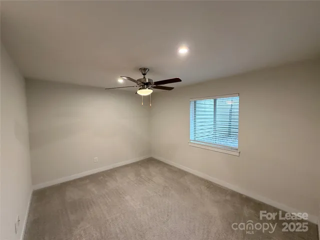 an empty room with a bathroom and a toilet