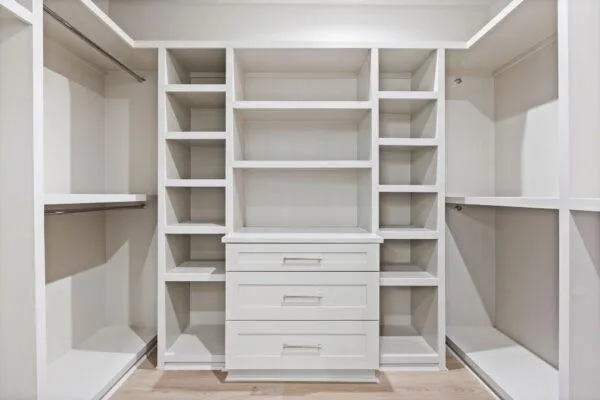 a view of walk in closet with empty racks