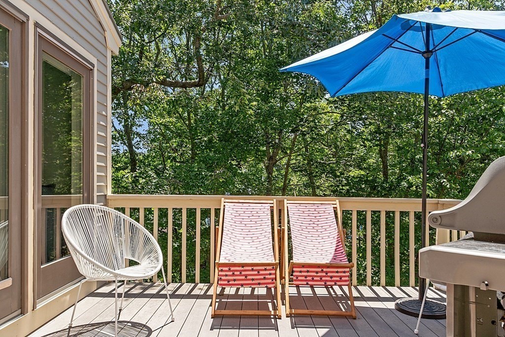 41 Quarry Ridge Lane, Unit 41 Rockport, MA 01966 - Photo 15 of 23 a view of a balcony with chair and an umbrella
