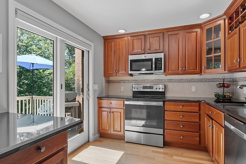41 Quarry Ridge Lane, Unit 41 Rockport, MA 01966 - Photo 2 of 23 a kitchen with a stove microwave and refrigerator