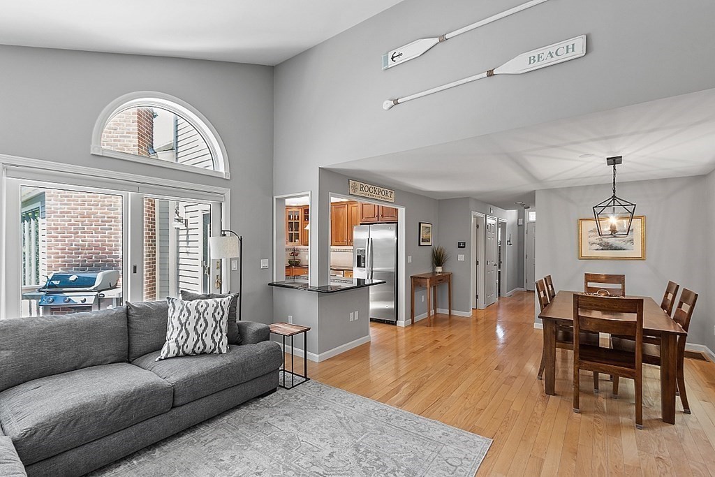 41 Quarry Ridge Lane, Unit 41 Rockport, MA 01966 - Photo 6 of 23 a living room with furniture a dining table and a large window