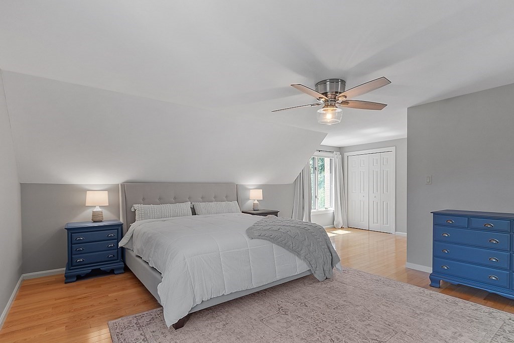 41 Quarry Ridge Lane, Unit 41 Rockport, MA 01966 - Photo 8 of 23 a bedroom with a large bed and a ceiling fan