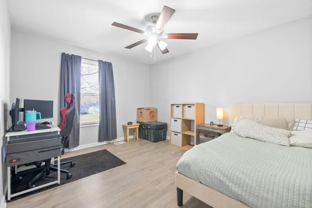 a bedroom with a bed and a desk