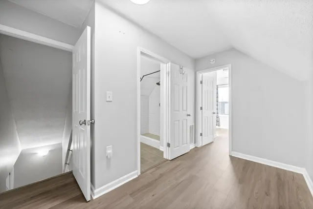 a view of a hallway with wooden floor