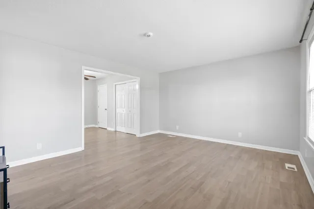 a view of an empty room and wooden floor