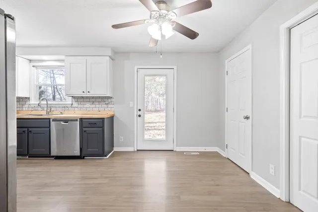 a view of a kitchen with a sink cabinets and wooden floor