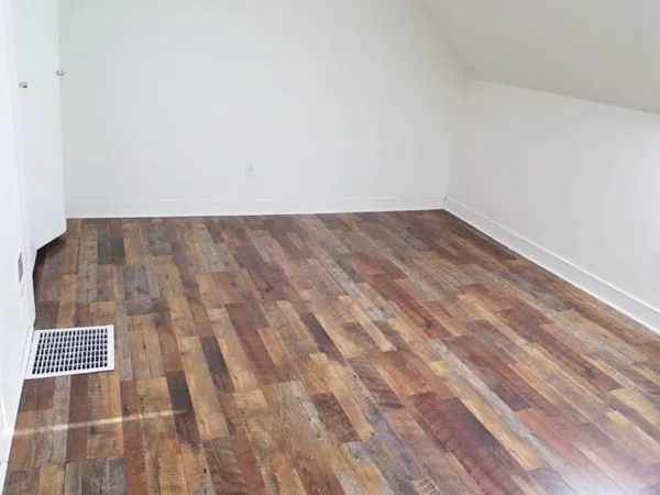 a view of a room with wooden floor