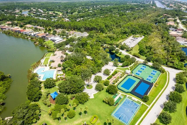 an aerial view of a house with a swimming pool yard and outdoor seating