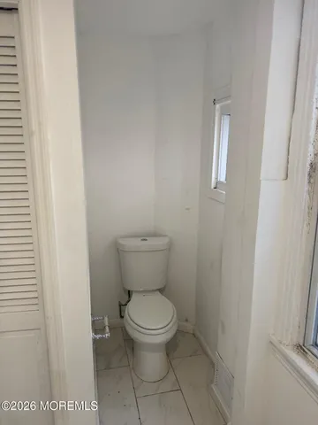 a white toilet sitting next to a sink