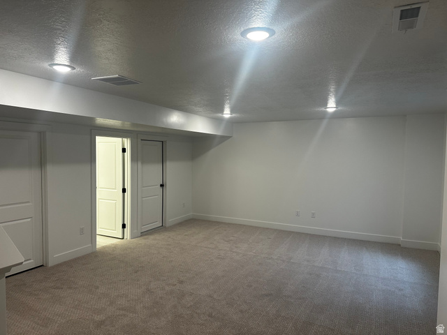 61 South Lunar Way Mapleton, UT 84664 - Photo 15 of 15 Finished below grade area featuring a textured ceiling and light colored carpet